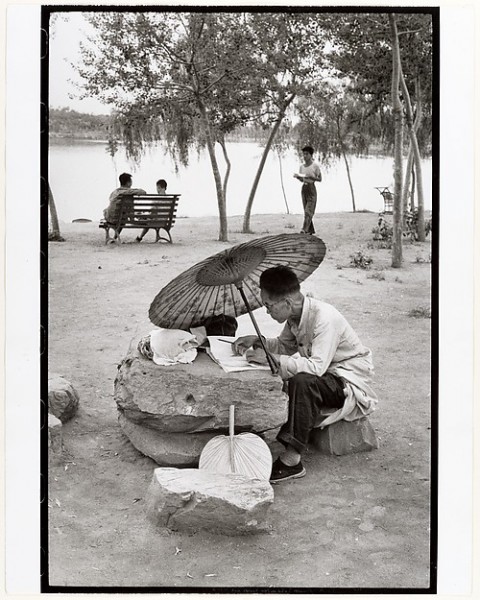 A Professor Corrects His Class Papers by the Lake in the Newly Build King Chan Park, Peking, Henri Cartier-Bresson, 1958, printed ca. 1972
